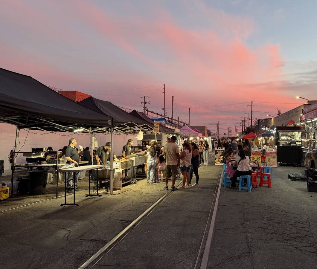 Sunset over the market alley with old rail tracks running down the middle and food stalls on both sides